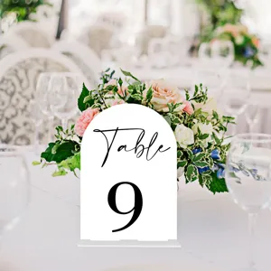 Acrylic wedding table number sign with arch design and black printed text for reception decor.
