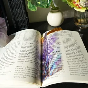 Translucent acrylic bookmark with gold tassel, elegant purple floral design for reading lovers.