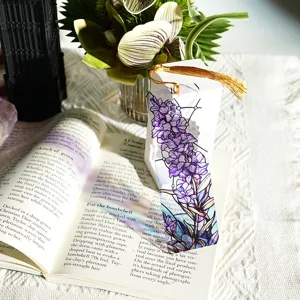 Detailed view of creative colorful translucent acrylic bookmark with golden tassel and floral design.
