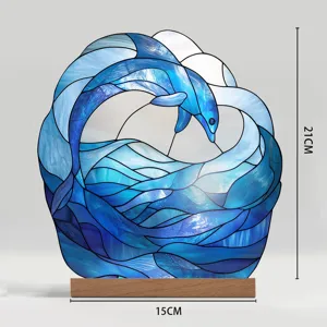 Close up detail view of stained glass dolphin wave acrylic ornament with wooden base support.