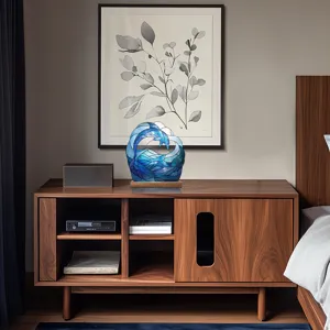 Detail view of the acrylic ocean wave and dolphin desktop ornament placed on a wooden sideboard.