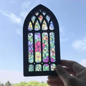 Close-up detail of the gothic arch stained glass window wooden hanging pendant in natural light.