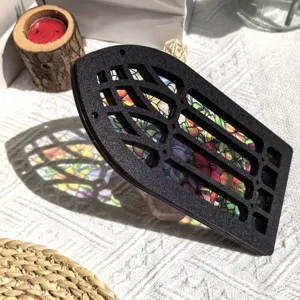 Stained glass wooden window ornament detail showing colorful floral panels and light shadow.