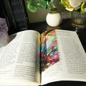 Detailed view of the stained glass style translucent acrylic bookmark with tassel, refracting colorful light.