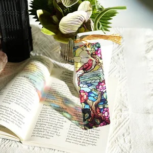 Detailed view of colorful translucent acrylic bookmark featuring bird flower design and gold tassel.