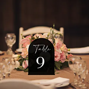 Acrylic arch table number sign with white print for wedding party table setting decor detail.