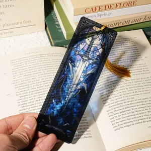 Acrylic stained glass sword bookmark with gold tassel, detailed transparent literary book page marker.