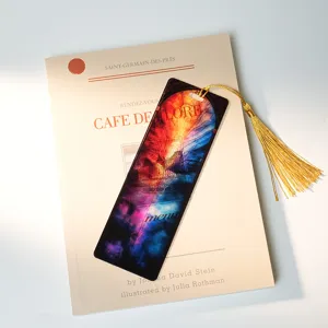 Translucent acrylic bookmark with gold tassel, stained glass galaxy design, detail view.