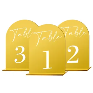 Detailed view of gold acrylic arch wedding table numbers with clear printed digits and stable base.