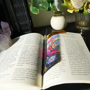 Close-up of colorful translucent refractive acrylic bookmark with elegant tassel detail.