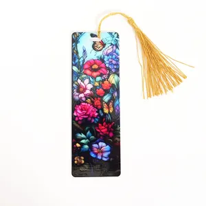 Detailed view of a colorful stained glass acrylic bookmark featuring floral art with gold tassel.