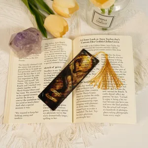 Translucent acrylic bookmark featuring intricate dragon pattern and elegant gold tassel.