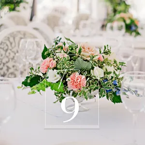 Clear acrylic arched wedding table number sign detail with stand for reception decor.