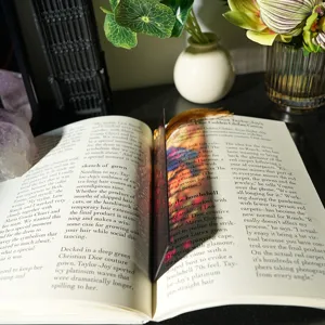 Close-up detail of colorful light-refracting acrylic bookmark with tassel and refractive design.