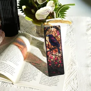 Acrylic stained glass raven bookmark with golden tassel, light-transmitting reading accessory.