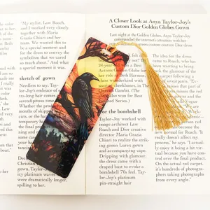 Detail shot of a creative translucent acrylic bookmark featuring a stunning raven design with tassel.