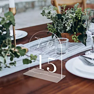 Clear acrylic arch table number sign with base for wedding reception and event decor display.