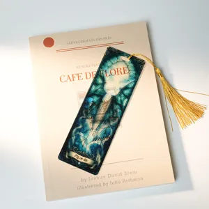 Translucent acrylic bookmark featuring a gothic dragon pattern with a delicate gold tassel.