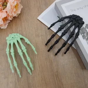 Halloween skeleton hand hair clips and decorations, black and green plastic spooky party props.