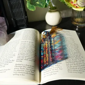 Colorful transparent acrylic bookmark with tassel, stained glass style light refraction.
