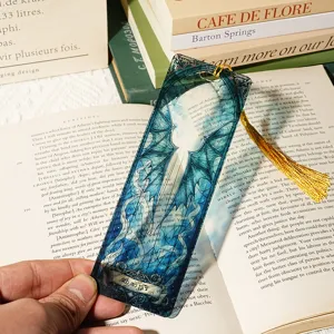 Translucent acrylic bookmark with dragon wing pattern and yellow tassel, literary design.