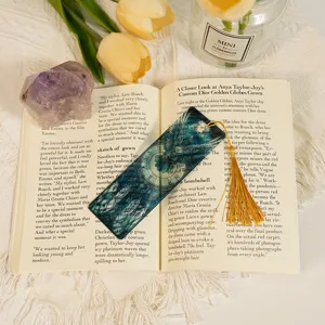 Transparent acrylic bookmark with dragon pattern and golden tassel, elegant student stationery.