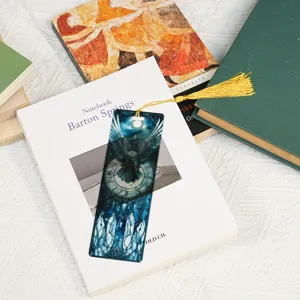 Translucent acrylic bookmark with gold tassel, fantasy dragon crystal pattern detail view.