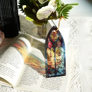 Detailed view of creative transparent stained glass acrylic bookmark with golden tassel.