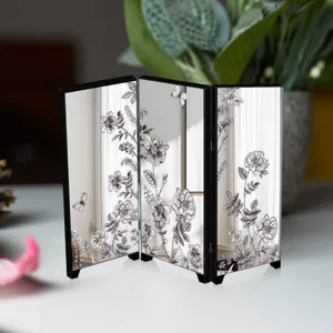 Detailed close-up of the mini desktop mirrored folding screen featuring elegant floral art.