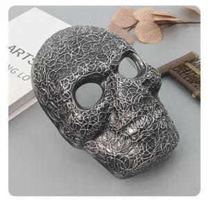 Detailed view of the silver and black skull mask, featuring a unique textured design for party.