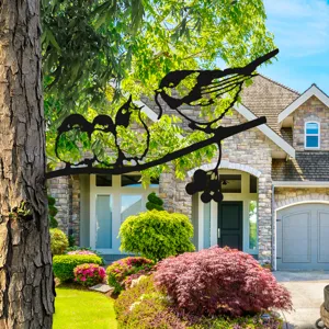 Metal bird tree silhouette garden art, outdoor branch decor piece for yard and fence display.