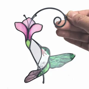 Metal hummingbird hanging ornament detail view, colorful glass window decoration for home.