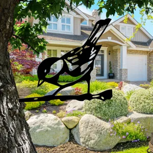 Metal bird garden stake silhouette for outdoor yard decor, tree art decoration detail.