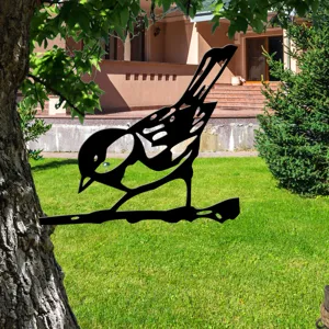 Detail view of black metal bird silhouette tree stake for outdoor garden yard decor.