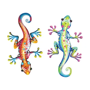 Close-up detail of colorful metal gecko wall art, vibrant hand-painted garden decor.