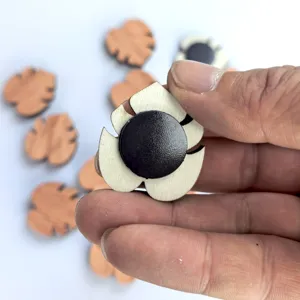 Detail view of the wooden leaf fridge magnet showing magnetic back and natural grain design.