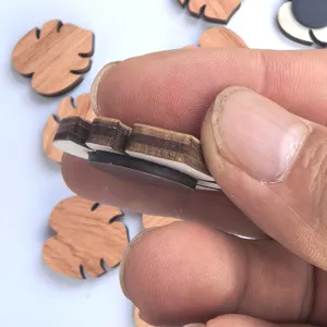 Wooden refrigerator magnet detail view showing thickness and magnetic backing design.
