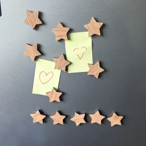 Wooden star magnetic pins detail view, decorative fridge stickers holding yellow memo notes.