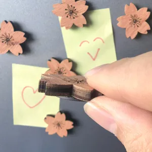 Wooden cherry blossom fridge magnet detail showcasing thickness and texture for decoration.