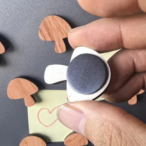 Wooden mushroom fridge magnet detail view, showing magnetic back and natural wood texture design.