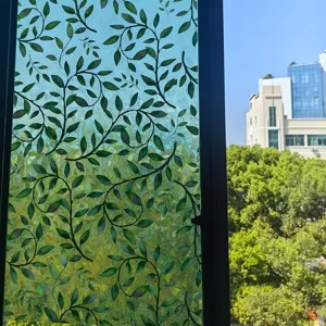 Detailed view of green leaf glass window film, offering privacy and colorful rainbow light.