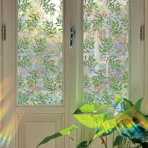 Decorative window film with green leaf pattern and prismatic rainbow effect for glass privacy.
