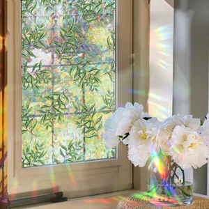 Window film detail showing vibrant leaf pattern and stunning prism rainbow light effect.