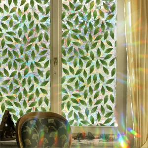 Rainbow window film detail showing vibrant green leaves pattern and colorful prismatic light effect.
