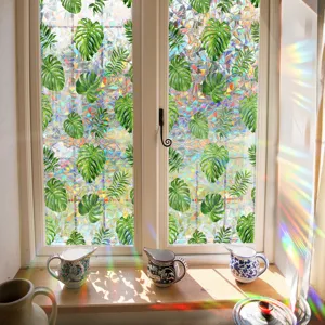 Detailed close-up of monstera leaf rainbow window film, casting stunning prismatic light.
