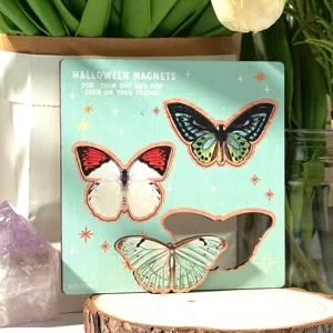 Wooden butterfly fridge magnet detail shot, showing vintage design and magnetic components.