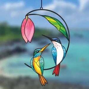 Detailed closeup view of vibrant colorful stained glass bird window hanging suncatcher.