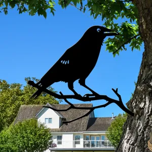 Outdoor metal raven branch silhouette garden decor detail view showing rustic black iron design.