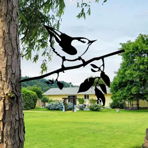 Metal bird tree silhouette garden ornament, outdoor iron art branch decor detail view.