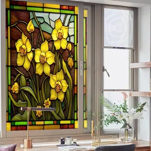 Stained glass window film detail featuring vibrant yellow daffodil floral pattern and green leaves.